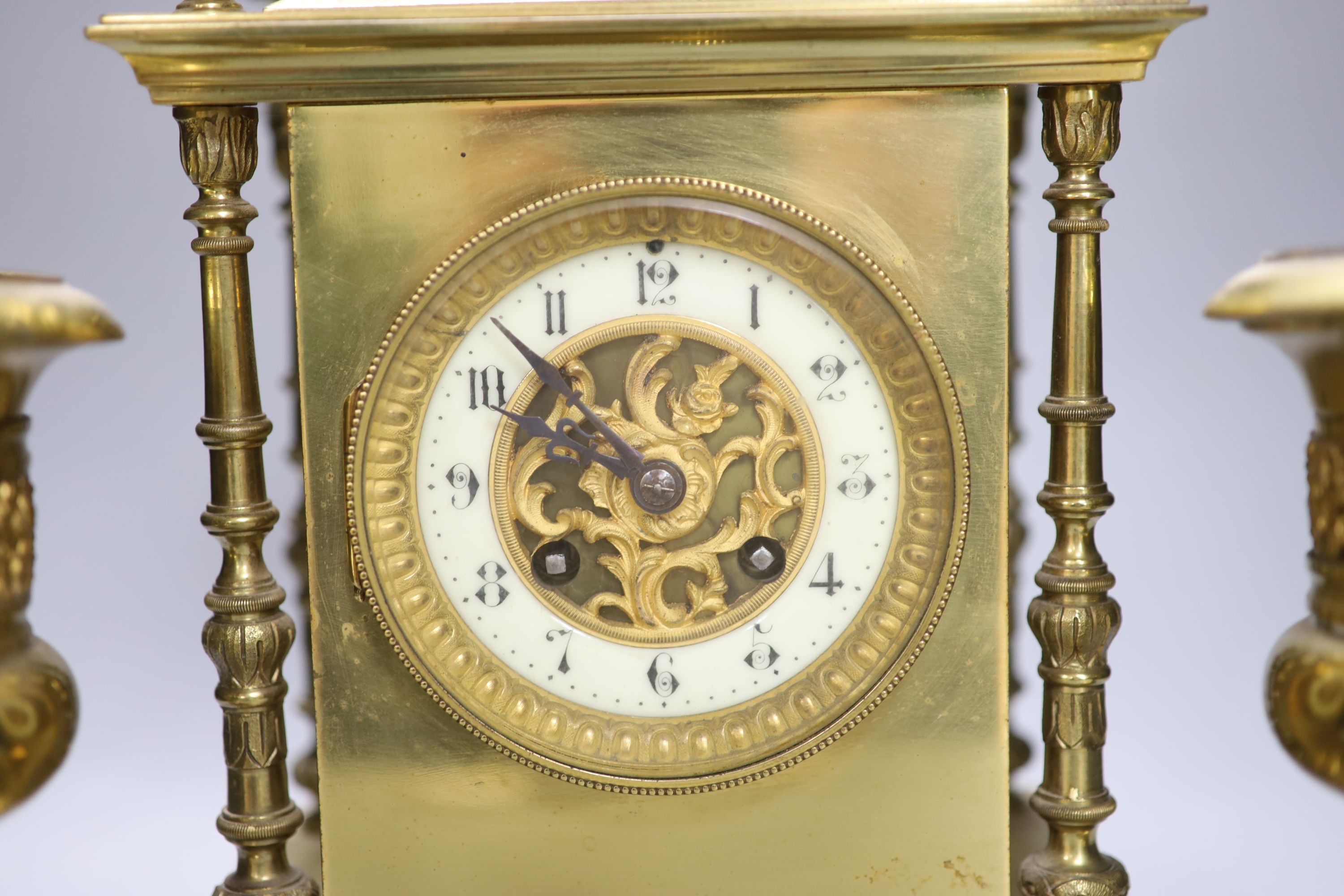 A late 19th century gilt brass three piece clock garniture, the clock with an eight day striking movement, height 39cm